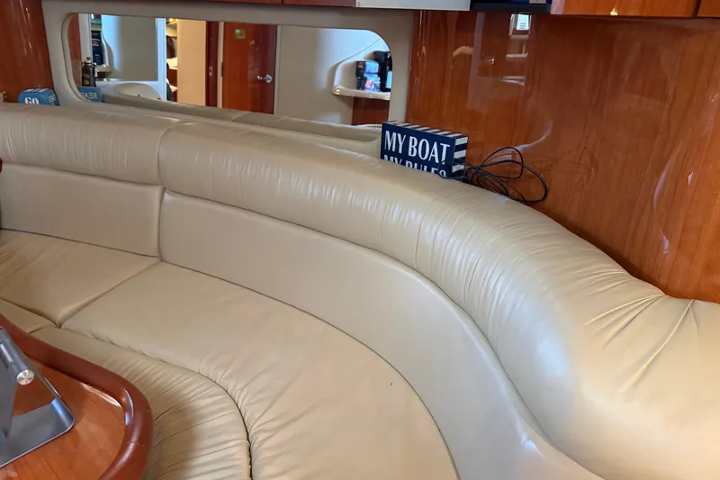 Slide: The Image of Interior of 2001 Sea Ray 380 Sundancer with beige leather seating and wooden accents. - 10
