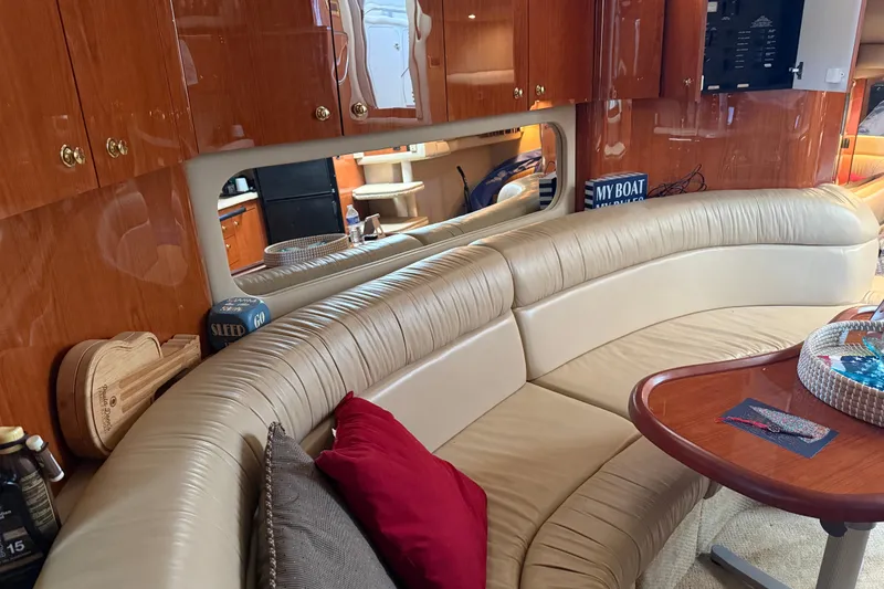 Slide: The Image of Luxurious interior of 2001 Sea Ray 380 Sundancer with leather seating and wooden cabinetry. - 13