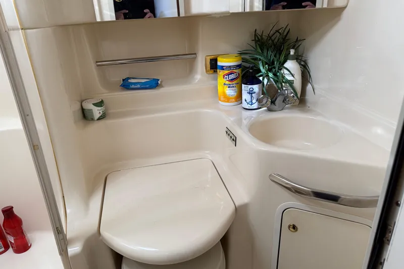Slide: The Image of Bathroom interior of 2001 Sea Ray 380 Sundancer with sink and cleaning supplies. - 15