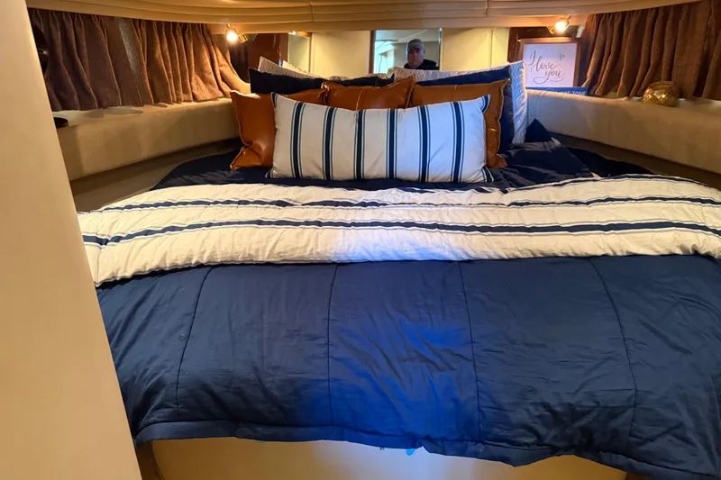 Slide: The Image of Luxurious cabin interior of 2001 Sea Ray 380 Sundancer with cozy bedding and ambient lighting. - 8