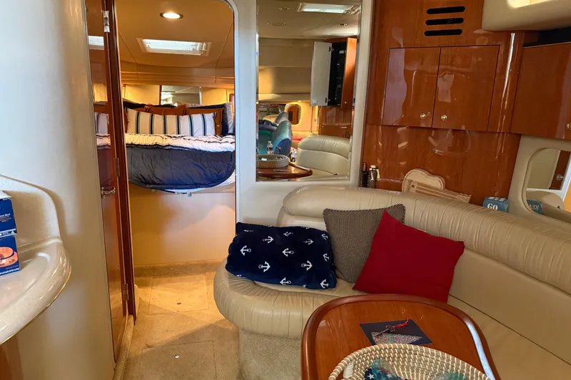 Slide: The Image of Interior of 2001 Sea Ray 380 Sundancer yacht with cozy seating and elegant wood finishes. - 9