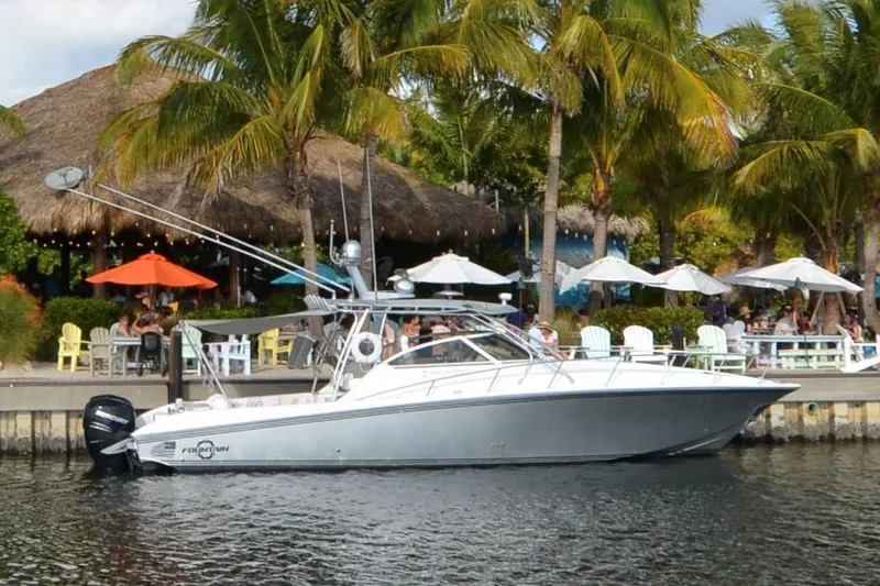The Image of 2007 Fountain 38 Sportfish Cruiser OB docked near tropical restaurant with palm trees. - 0