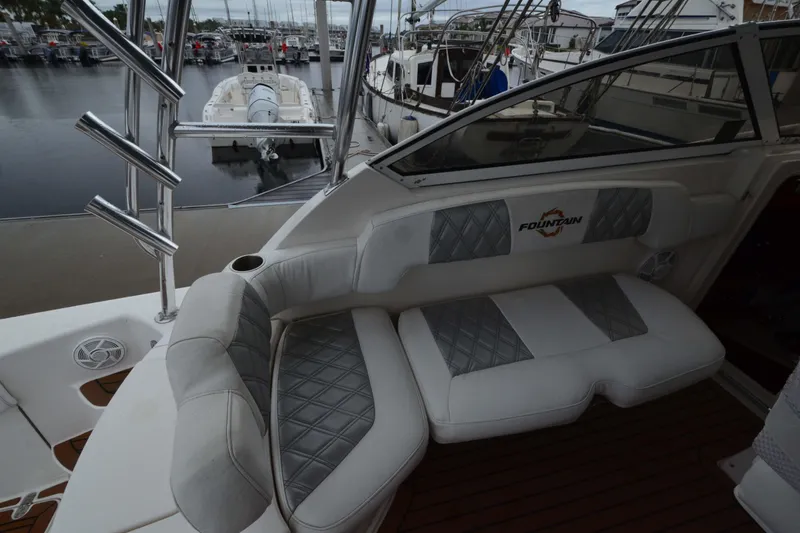 Slide: The Image of 2007 Fountain 38 Sportfish Cruiser OB interior with cushioned seating and marina view. - 11
