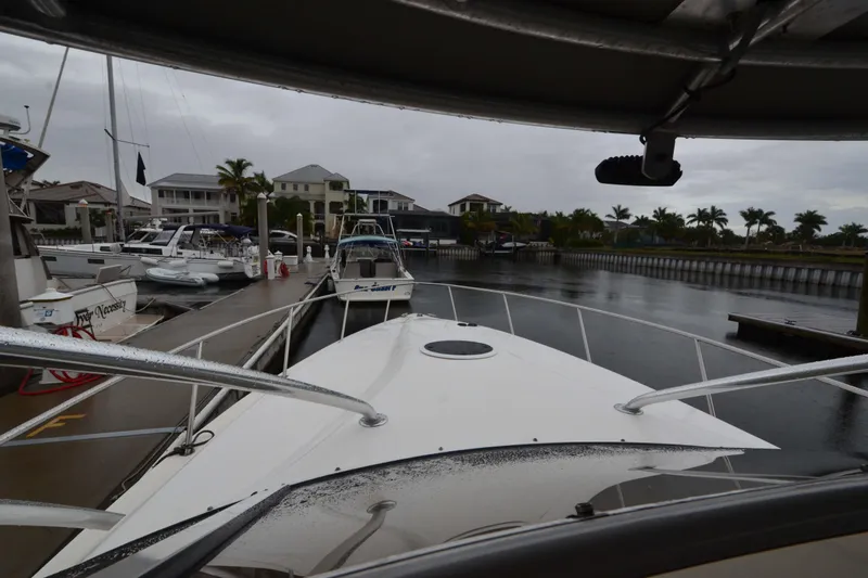 Slide: The Image of 2007 Fountain 38 Sportfish Cruiser OB docked at marina with overcast sky. - 12