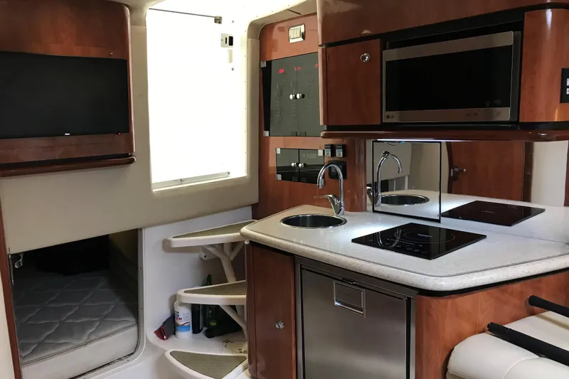 Slide: The Image of 2007 Fountain 38 Sportfish Cruiser OB interior with kitchenette, microwave, and TV. - 16