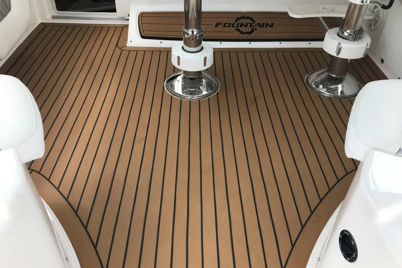 Slide: The Image of 2007 Fountain 38 Sportfish Cruiser OB deck with teak flooring and seating. - 19