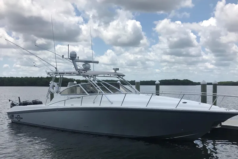 Slide: The Image of 2007 Fountain 38 Sportfish Cruiser OB docked on a calm, cloudy day. - 2