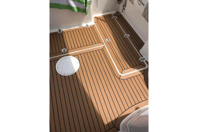 Slide: The Image of 2007 Fountain 38 Sportfish Cruiser OB deck with teak-style flooring. - 20