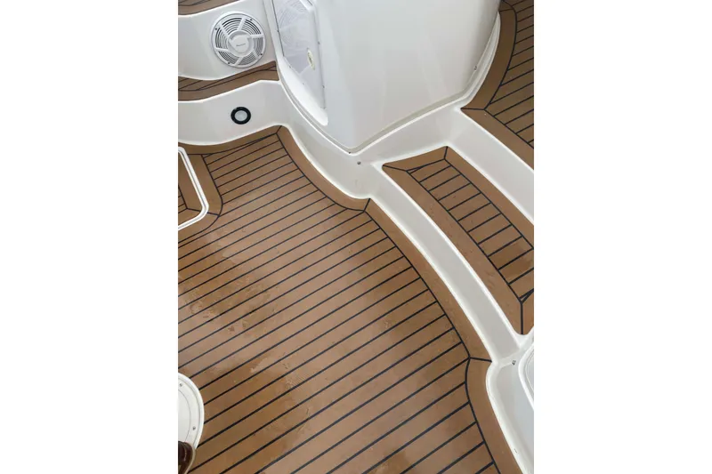 Slide: The Image of 2007 Fountain 38 Sportfish Cruiser OB deck with teak flooring and speaker. - 21