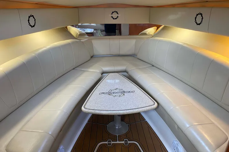 Slide: The Image of 2007 Fountain 38 Sportfish Cruiser OB interior with beige seating and branded table. - 23