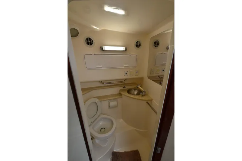 Slide: The Image of 2007 Fountain 38 Sportfish Cruiser OB bathroom with toilet, sink, and storage cabinets. - 31