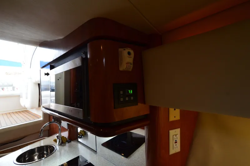 Slide: The Image of 2007 Fountain 38 Sportfish Cruiser OB interior kitchen with microwave and sink. - 34