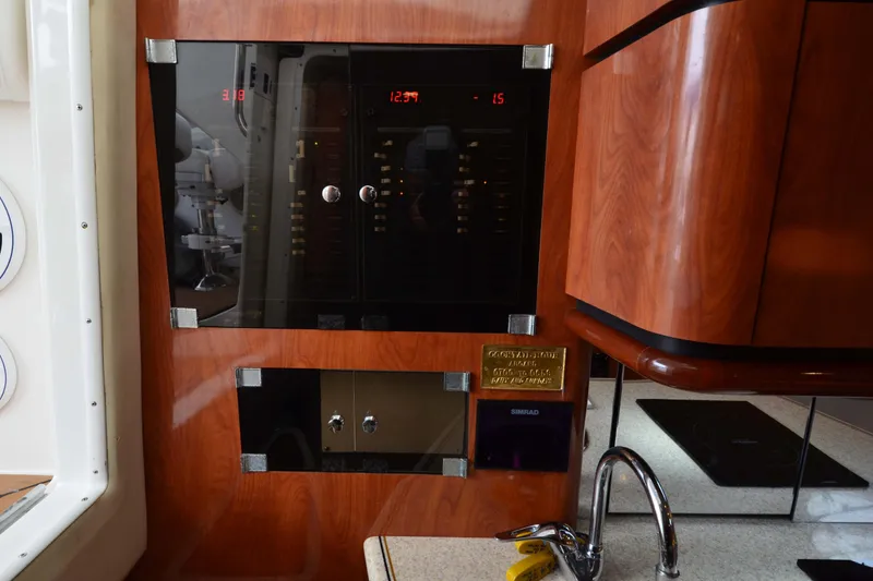Slide: The Image of Control panel inside 2007 Fountain 38 Sportfish Cruiser OB, featuring wood finish and modern equipment. - 36
