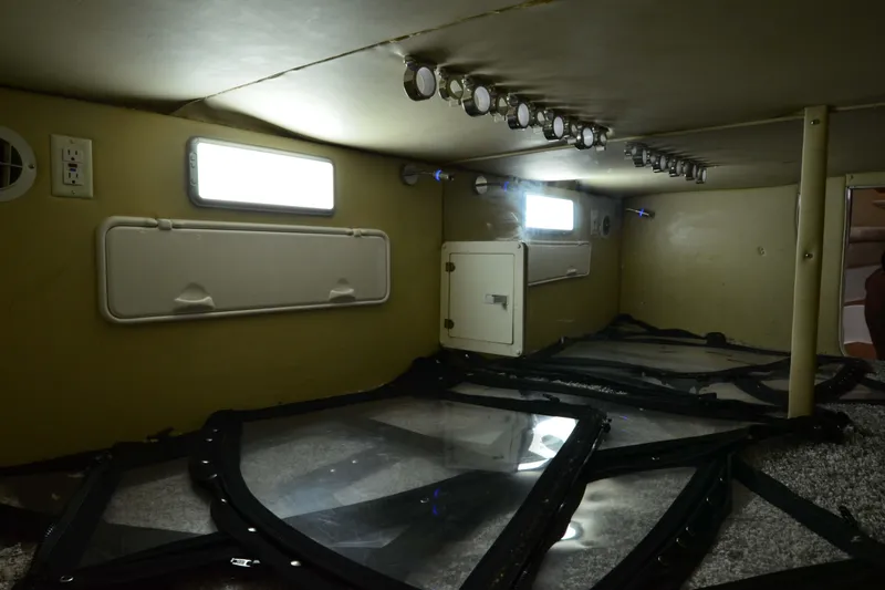 Slide: The Image of 2007 Fountain 38 Sportfish Cruiser OB interior storage area with lighting and access panels. - 38