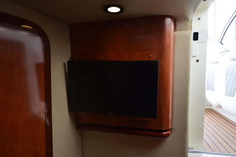 Slide: The Image of Interior of 2007 Fountain 38 Sportfish Cruiser OB with mounted TV and wooden paneling. - 42