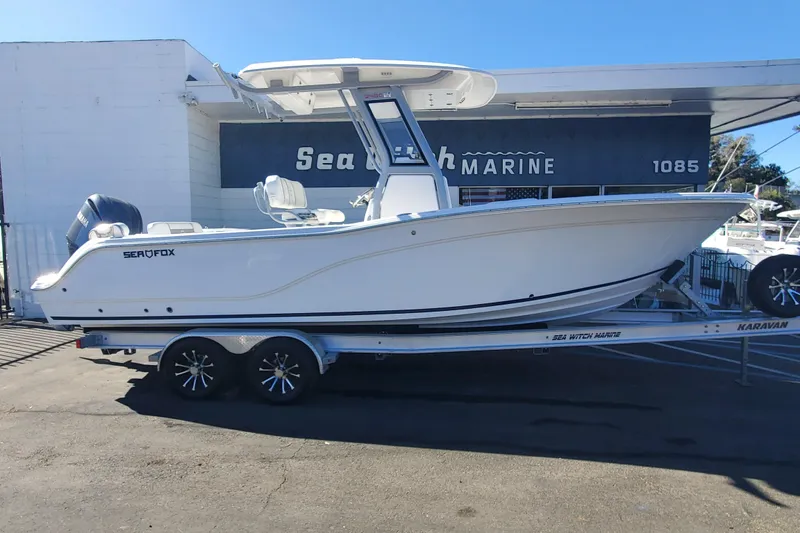 The Image of 2026 Sea Fox 248 Commander boat on trailer outside marine shop. - 0