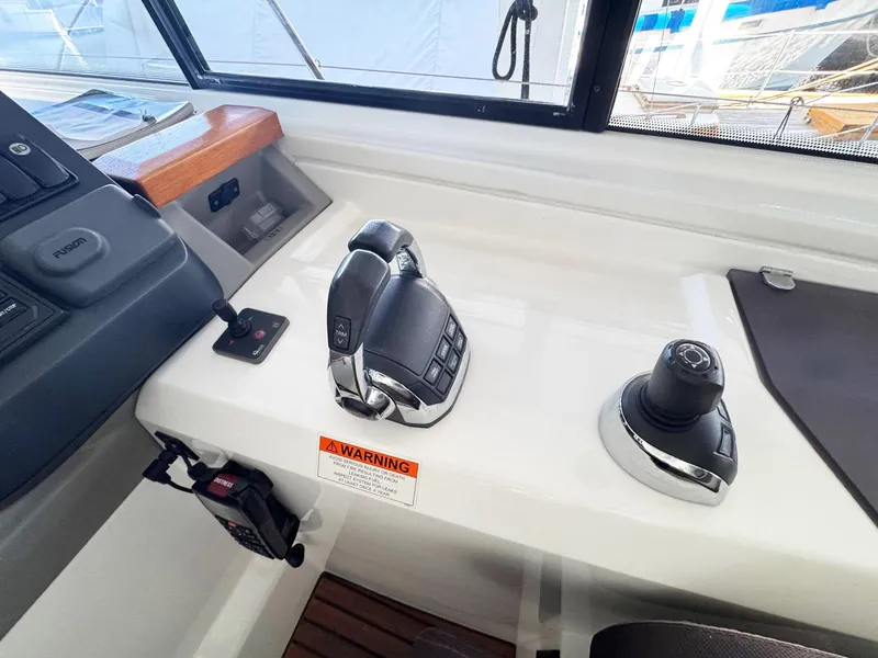 Slide: The Image of Control panel of a 2015 Beneteau Gran Turismo 44 yacht, featuring throttle and joystick controls. - 13