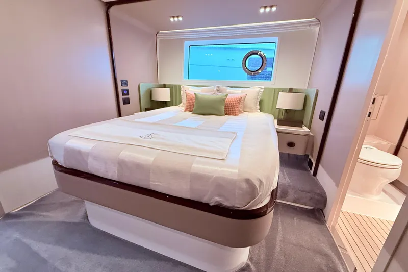 Slide: The Image of Luxurious bedroom interior of 2020 Azimut 60 yacht with modern decor and window view. - 13