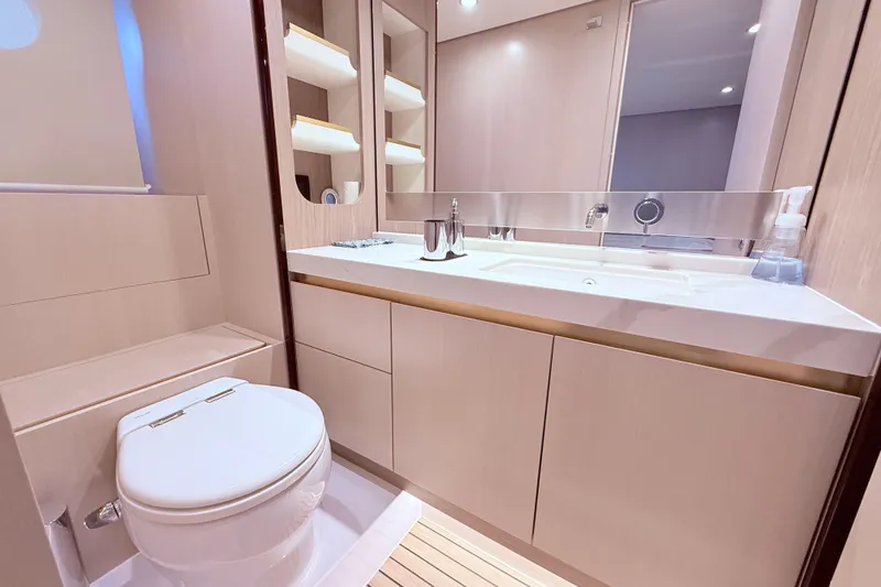 Slide: The Image of Luxurious bathroom in a 2020 Azimut 60 yacht, featuring modern fixtures and elegant design. - 15