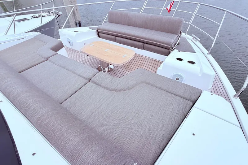 Slide: The Image of Luxurious 2020 Azimut 60 yacht deck with comfortable seating and wooden table. - 25