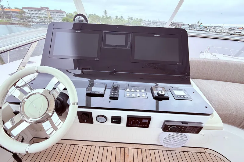 Slide: The Image of Helm of 2020 Azimut 60 yacht with modern navigation controls and steering wheel. - 27