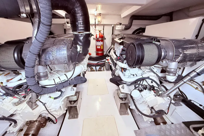 Slide: The Image of Engine room of a 2020 Azimut 60 yacht, featuring dual engines and a fire extinguisher. - 30