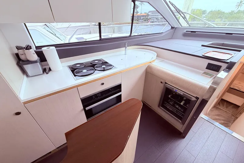 Slide: The Image of Modern kitchen interior on a 2020 Azimut 60 yacht, featuring sleek appliances and ample counter space. - 7