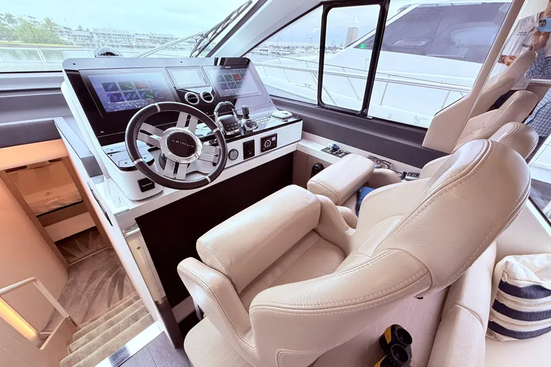 Slide: The Image of Luxurious helm of 2020 Azimut 60 yacht with modern controls and leather seating. - 8