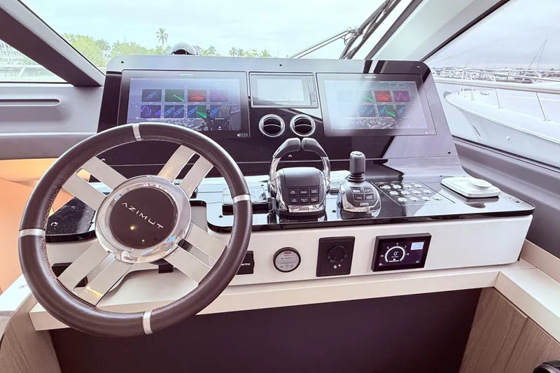 Slide: The Image of Cockpit of 2020 Azimut 60 yacht with advanced navigation controls and dual screens. - 9