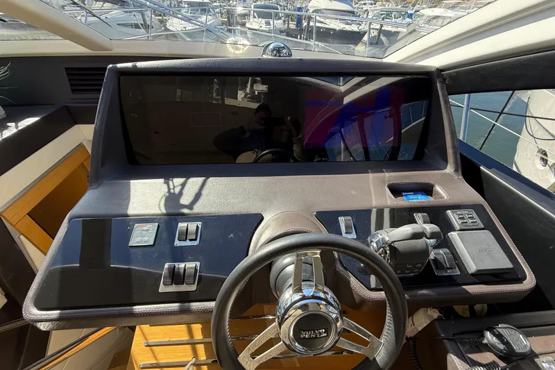 Slide: The Image of Helm of 2017 Schaefer 56 yacht with modern controls and steering wheel. - 17