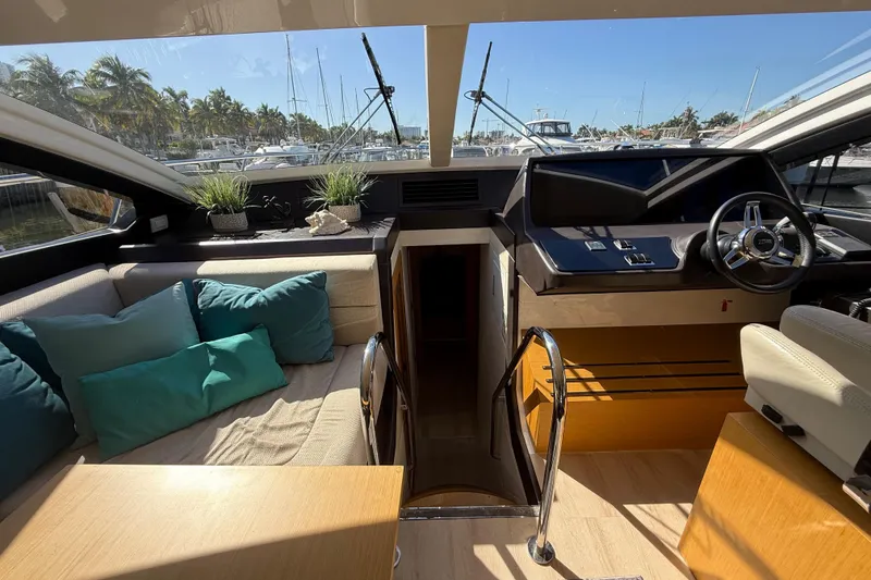 Slide: The Image of Luxurious 2017 Schaefer 56 yacht interior with helm, seating, and scenic marina view. - 20