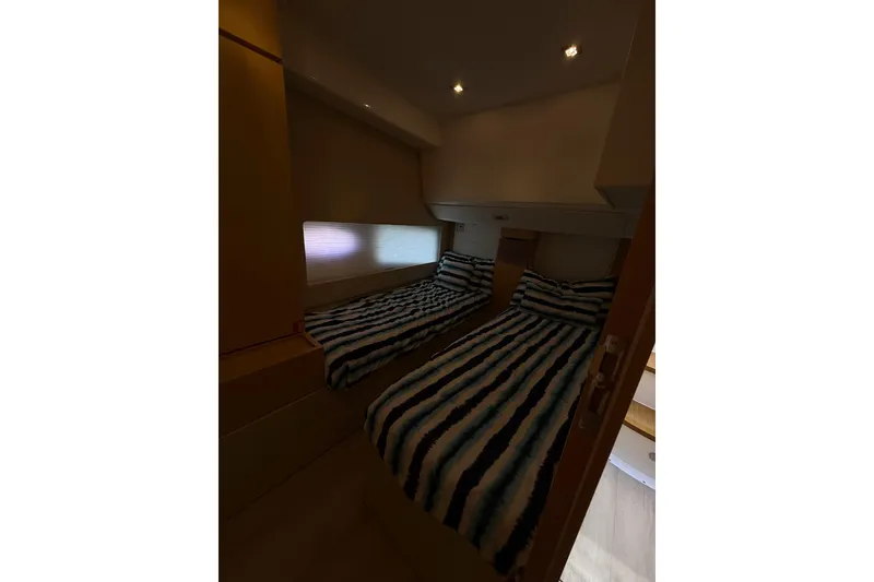 Slide: The Image of Twin beds in a 2017 Schaefer 56 yacht cabin with striped bedding. - 29