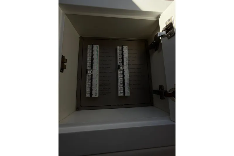 Slide: The Image of Electrical panel inside Schaefer 56 yacht, 2017 model, with labeled switches. - 33