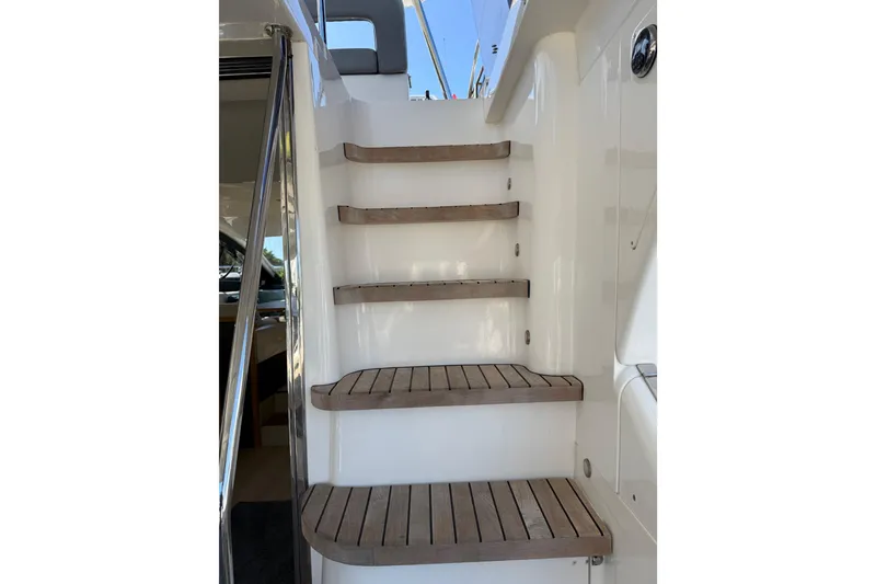 Slide: The Image of Staircase on 2017 Schaefer 56 yacht with wooden steps and white railing. - 34