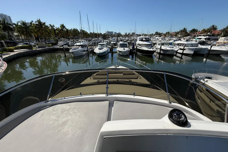 Slide: The Image of Bow view of 2017 Schaefer 56 yacht docked in a marina with palm trees. - 38