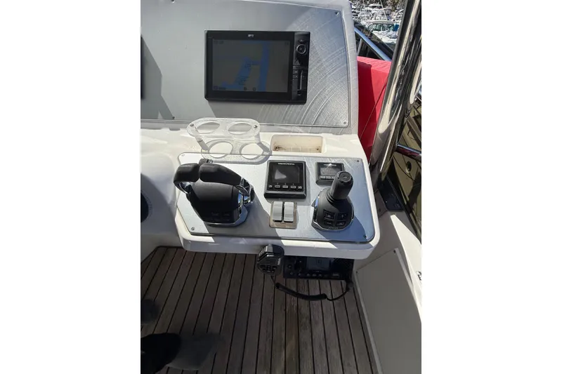 Slide: The Image of Control panel of a 2017 Schaefer 56 yacht with navigation screen and joystick. - 39