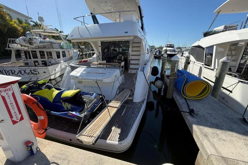 Slide: The Image of Luxury Schaefer 56 yacht docked with jet ski, 2017 model, sunny marina setting. - 4