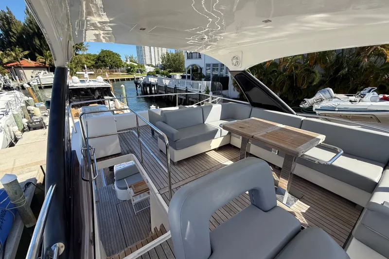 Slide: The Image of Luxurious 2017 Schaefer 56 yacht deck with seating and table, docked at marina. - 40