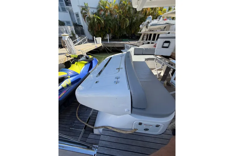 Slide: The Image of 2017 Schaefer 56 yacht docked with jet ski nearby. - 51