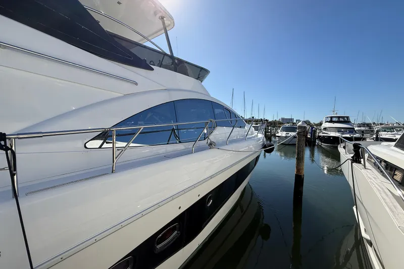 Slide: The Image of 2017 Schaefer 56 yacht docked at marina under clear blue sky. - 6
