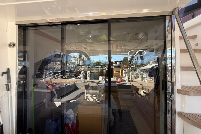 Slide: The Image of Luxurious 2017 Schaefer 56 yacht interior with glass doors and marina view. - 8