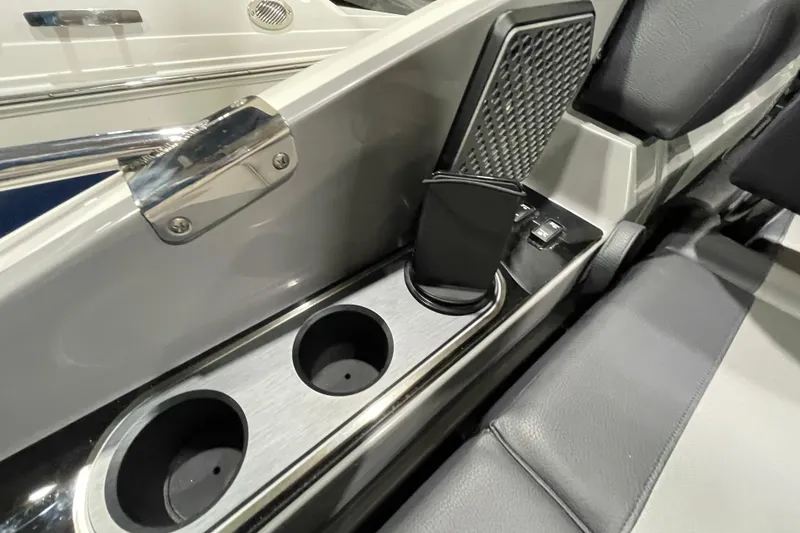 Slide: The Image of 2026 Harris Crowne 250 boat interior with cup holders and sleek seating design. - 11