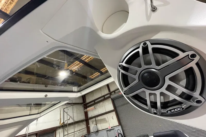 Slide: The Image of 2026 Harris Crowne 250 boat interior with JL Audio speaker and glass roof detail. - 13