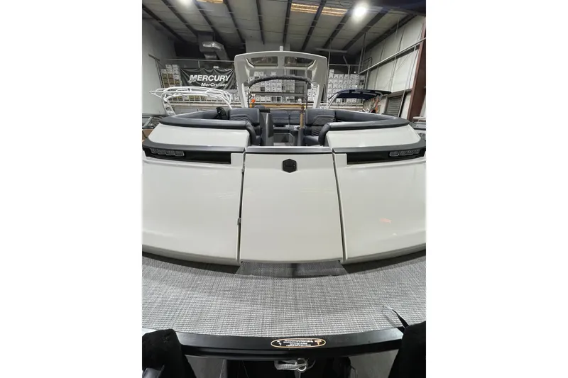 Slide: The Image of 2026 Harris Crowne 250 boat in showroom, rear view with sleek design. - 2