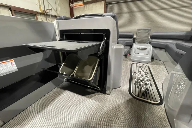 Slide: The Image of 2026 Harris Crowne 250 interior with open storage compartments and modern seating. - 20