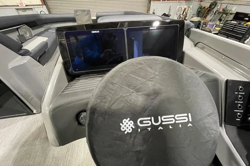Slide: The Image of 2026 Harris Crowne 250 boat dashboard with dual Simrad displays and Gussi Italia steering wheel. - 21