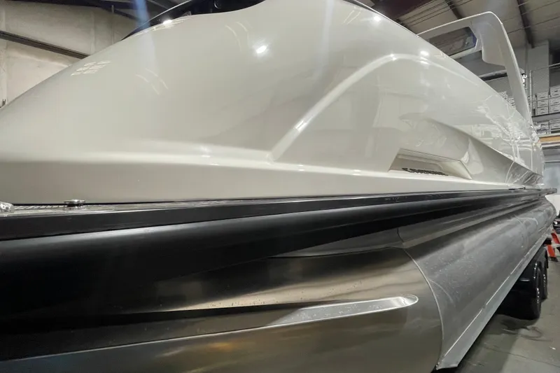 Slide: The Image of 2026 Harris Crowne 250 pontoon boat, sleek design, indoor setting, close-up view. - 3