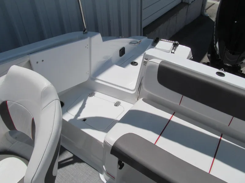 Slide: The Image of 2023 Tahoe 2150 boat interior with white and gray seating, modern design. - 16