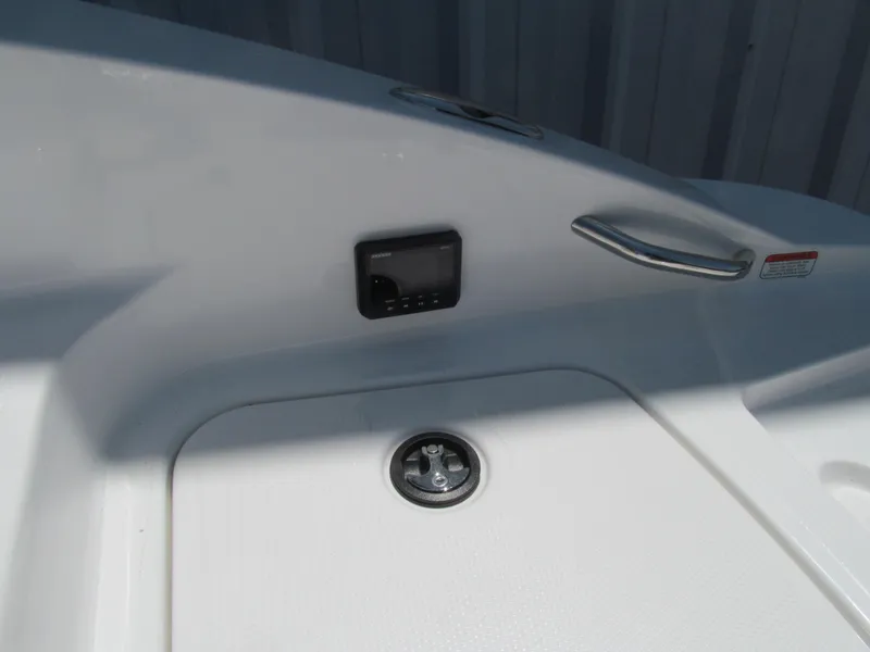 Slide: The Image of 2023 Tahoe 2150 boat interior with control panel and handle detail. - 18