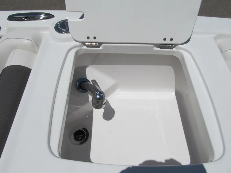 Slide: The Image of 2023 Tahoe 2150 boat sink with open lid and faucet. - 9